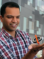 Amar Vutha holding a gyroscope.